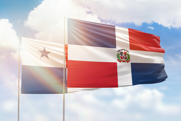 Sunny blue sky and flags of dominican republic and panama