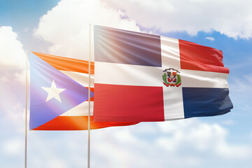 Sunny blue sky and flags of dominican republic and puerto rico