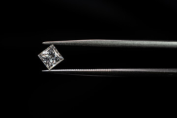 Princess cut diamond with tweezers