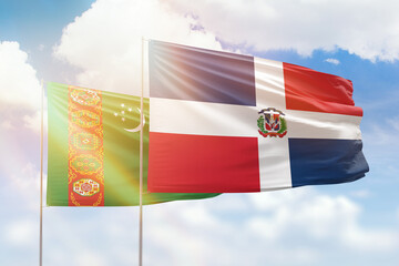 Sunny blue sky and flags of dominican republic and turkmenistan