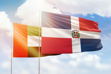 Sunny blue sky and flags of dominican republic and uae