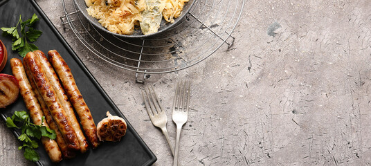 Plate with tasty grilled sausages and sauerkraut on grunge background with space for text, top view
