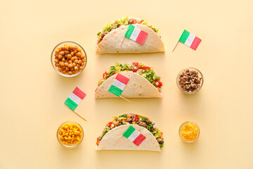 Composition with Mexican traditional tacos and flags on beige background
