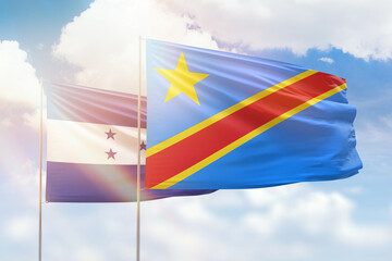 Sunny blue sky and flags of dr congo and honduras