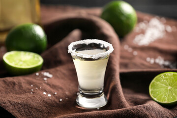 Shot of tasty mexican tequila on table
