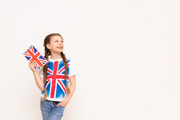 A girl holding an English book points to your advertisement on an isolated background. Teaching...