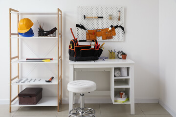 Interior of room with workplace, shelf unit and different modern tools
