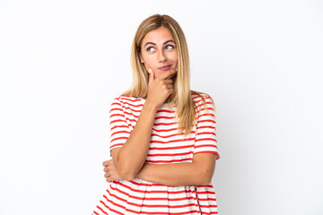 Blonde Uruguayan girl isolated on white background thinking an idea while looking up