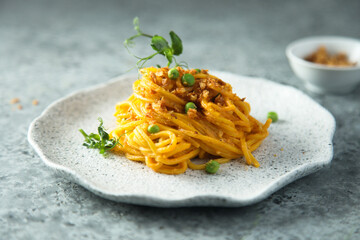 Pasta with red pesto and green pea