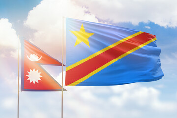 Sunny blue sky and flags of dr congo and nepal