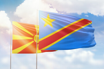 Sunny blue sky and flags of dr congo and north macedonia
