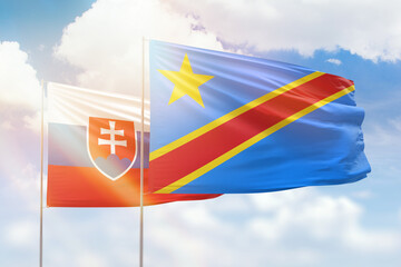 Sunny blue sky and flags of dr congo and slovakia