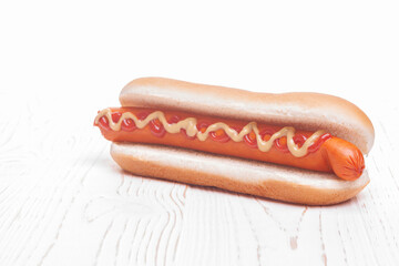 hot do with mustard and ketchup on white wooden background