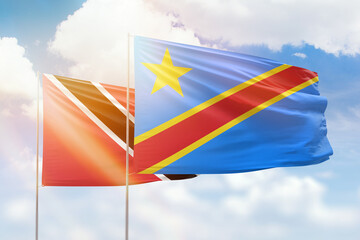 Sunny blue sky and flags of dr congo and trinidad and tobago