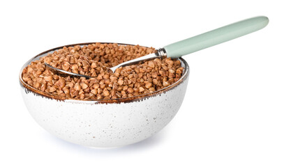 Bowl with buckwheat grains and spoon on white background