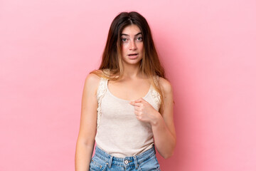 Young caucasian woman isolated on pink background pointing to oneself