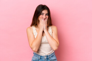Young caucasian woman isolated on pink background happy and smiling covering mouth with hands