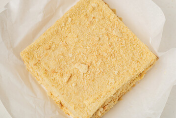 A whole napoleon cake. Vegetarian homemade cake on a white background.