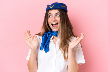 Airplane stewardess caucasian woman isolated on pink background with surprise facial expression
