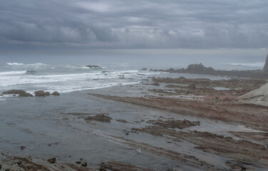 NORTH BEACH WITH LOW TIDE AND CLOUDY SPRING SKY
