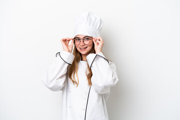 Young caucasian chef woman isolated on white background with glasses and surprised