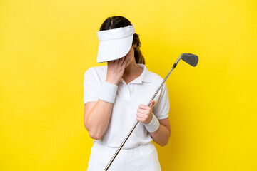 young caucasian woman playing golf isolated on yellow background with tired and sick expression