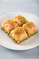  Pistachio baklava on a white plate.Traditional Turkish baklava on a white background
