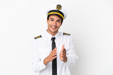 Airplane pilot over isolated white background applauding after presentation in a conference