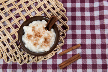 traditional sweet from the Brazilian June festivals, made of white corn with coconut and condensed milk and sprinkled with cinnamon