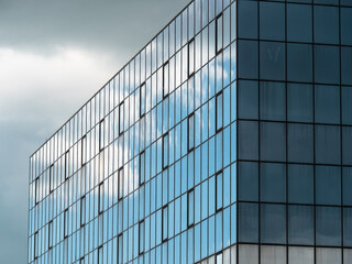 Fototapeta na wymiar Modern Building Glass Facade Reflecting Cloudy Blue Sky