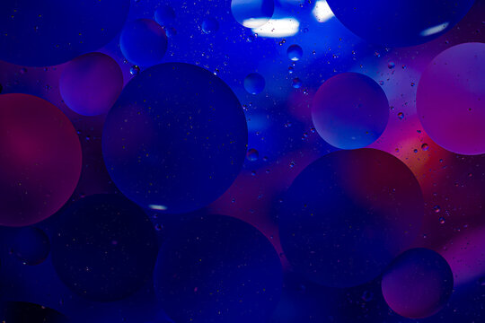 Photo of oil on a water surface with bubbles. Abstract colorful background. Macro close-up, not illustration