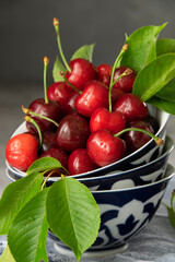 Fresh picked cherries in antique plates, dark food photography