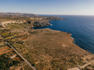 Rocky West Coast of Malta with cliffs, the sea and a blue sky