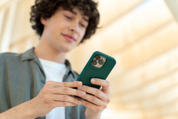 Caucasian man smiling happy using smartphone at the city