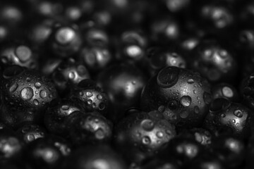 Beautiful background with mother-of-pearl black pearls, top view. Abstract texture for festive backgrounds. Shiny surface of male background. Gems close-up. Silver bright background.