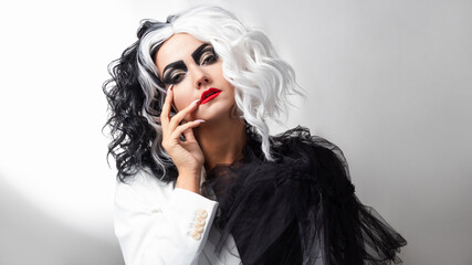 A fatal beauty in a daring fashion image with black and white hair. A rebellious stylish image for...