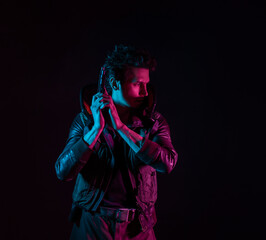 A guy in a cyberpunk image, holding a gun in his hands. Futuristic character. A young man in neon...