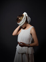 An antique heroine blindfolded, a young woman in a tunic with a blindfold, a contrasting portrait...