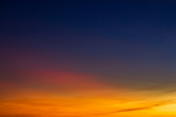 Sunset sky in the evening on twilight with colorful orange sunlight clouds, Dusk sky background 