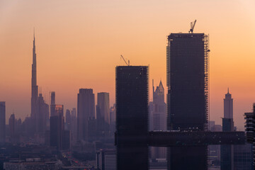 Fototapeta na wymiar Dubai skyline by sunset with modern towers near Financial centre and trade center with Burj Khalifa in the background, Dubai, UAE