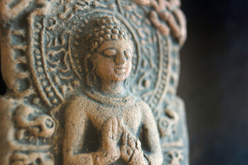 Close up macro of a meditating buddha stone statue