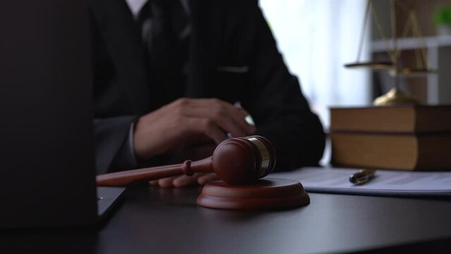 Judge banging gavel on courtroom desk.