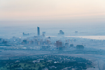 Fototapeta premium View of foggy skyline by sunrise of Dubai neighbourhood in the west of Dubai. 