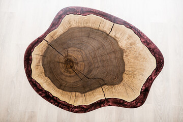 table made of natural wood and burgundy epoxy resin