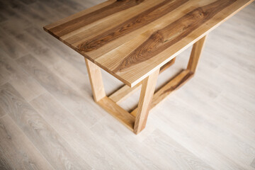 natural wood table on wooden legs in the interior
