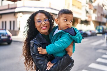 Mother and son hugging each other standing at park