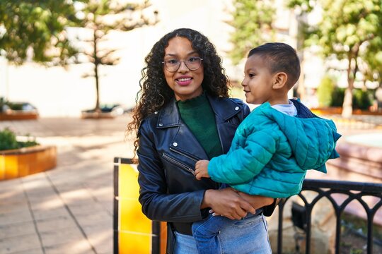 Mother and son hugging each other standing at park