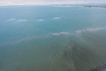 Israeli coast of the Dead Sea. salt mushroom  crystals formations, clear cyan green calm water...