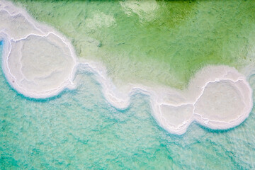 Israeli coast of the Dead Sea. salt mushroom  crystals formations, clear cyan green calm water...