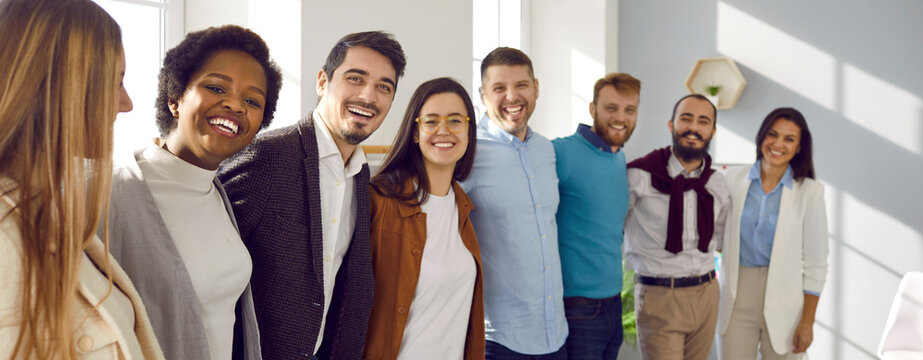 Narrow banner wide shot portrait of smiling international businesspeople show unity and leadership at workplace. Overjoyed diverse multiethnic employees team in office. Teamwork concept.